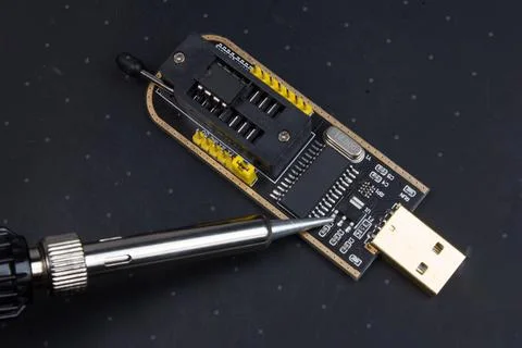 Program the chip and Soldering iron, electronics repair Stock Photos