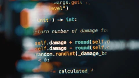 Program code on computer display in magnifying glass. Close-up Stock Footage 145087656