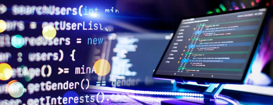 Program code on a computer monitor with fiber optic background. Internet an.. Stock Photos