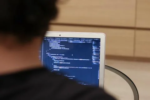 Program code on a laptop. Web application development. A view from the back o Foto stock