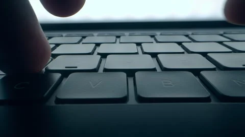 A program coder is typing on laptop keyboard close up macro. Hacker is using Stock Footage 241044472