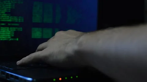 Program developer coding a software script on his black laptop. Stock Footage 219781595