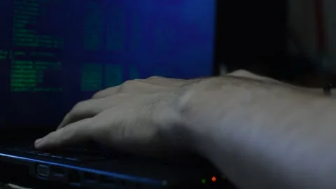 Program developer coding a software script on his black laptop. Stock Footage 219781624