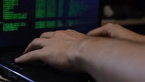 Program developer coding a software script on his black laptop. Stock Footage 219781660