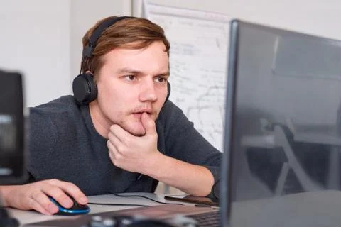 Program developer working at his desk. Virtual office operator. Stock Photos