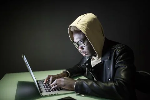 Program development concept. Young afro american man working with computer in Stock Photos