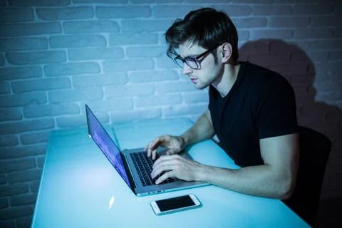 Program development concept young man working with computer in the night Stock Photos