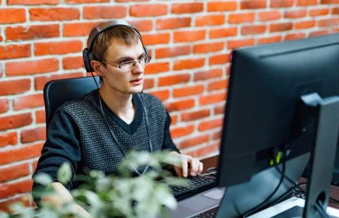 Program development concept. Young man working with computer Stock Photos