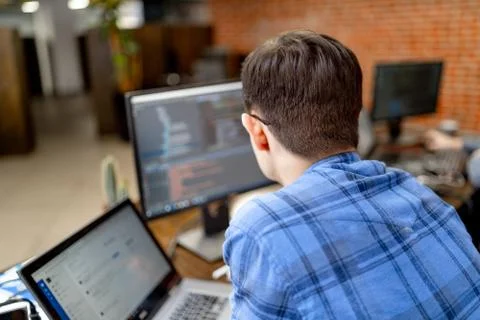 Program development concept. Young man working with computer. 스톡 사진