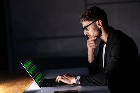 Program development concept. Young man working with computer in the night 스톡 사진