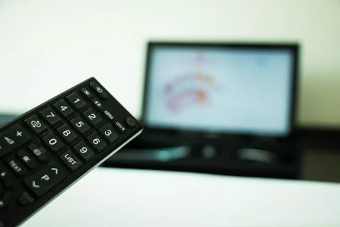 Program switching or button pressing on TV remote control Stock Photos