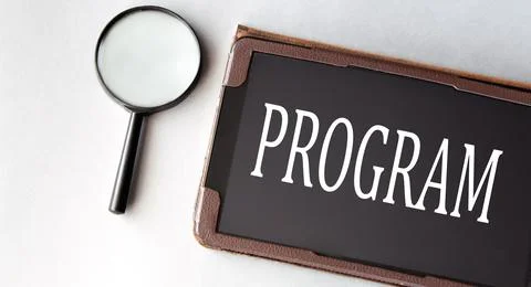 PROGRAM - word in electronic notebook on white background with magnifying gla 写真素材