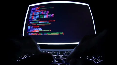 Programer Hacker typing on a laptop keyboard at night Man programmer hands Stock Footage 334586273