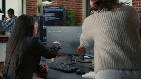 Programer pointing pencil at computer screen with software compiling code Stock Footage 168236713