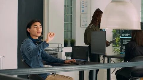 Programer typing source code on computer and turning head to use ar hologram 写真素材