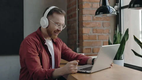 Programer using laptop for video connection, looking at webcam and talking. Stock Footage 176448912