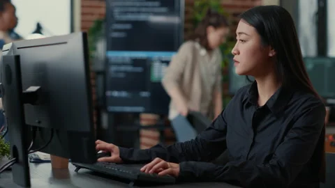 Programer writing algorithm focused on compiling source code sitting at desk Stock Footage 168233708