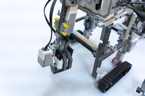 Programmable children's robot with grippers on a crawler platform Stock Photos