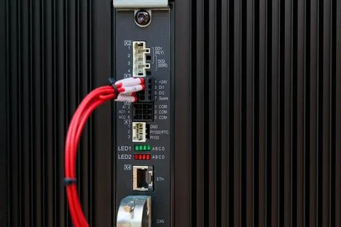 Programmable logic controller with red cable connecting to input output modul Stock Photos