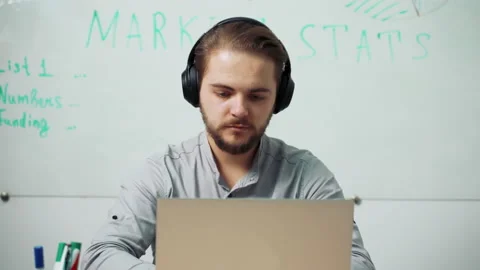  The programmer adjusts the headphones Stock-Footage 165875122
