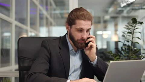 Programmer agreeing with interlocutor while talking on smartphone in cabinet 스톡 동영상 257294069