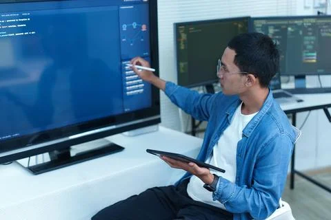 Programmer Analyzing Code and Digital Data on Multiple Screens Stock Photos