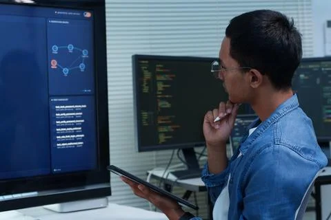 Programmer Analyzing Code and Digital Workflow 写真素材