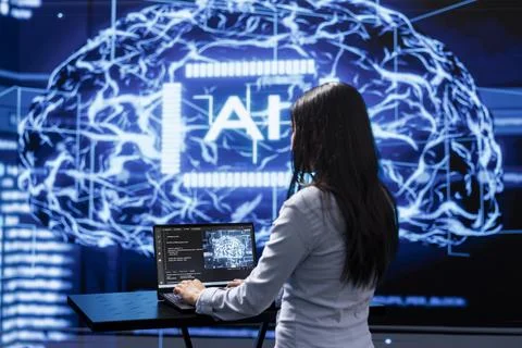 Programmer analyzing complex AI brain models on laptop, running simulations Foto stock
