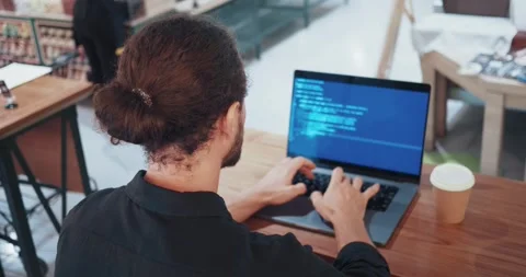 Programmer analyzing data. A male programmer involved in software development or Stock Footage 253503214