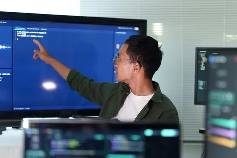 Programmer Analyzing Software Code on Technology Screens Fotos Stock