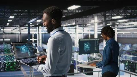 Programmer and colleague in data center reviewing AI LLM visualizations Stock Photos