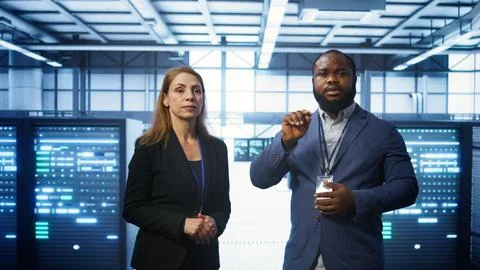 Programmer and colleague working on securing server room hardware using AR Stock Photos