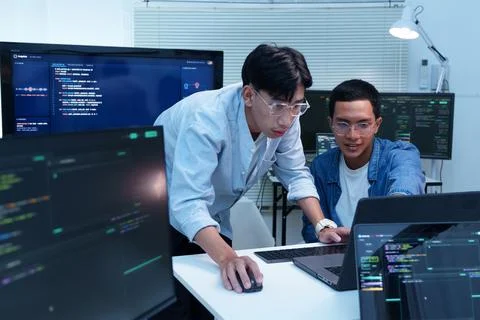 Programmer and Developer Collaborating on Digital Software Project Stock Photos