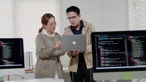 Programmer and Developer Collaborating on Software Code Video stock 343638498