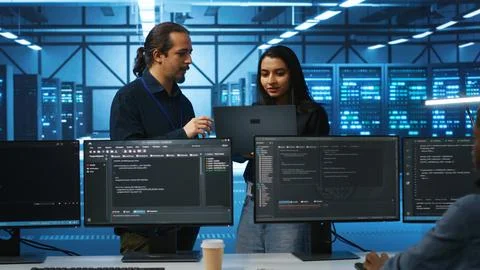 Programmer and supervisor in server room doing brainstorming 스톡 사진