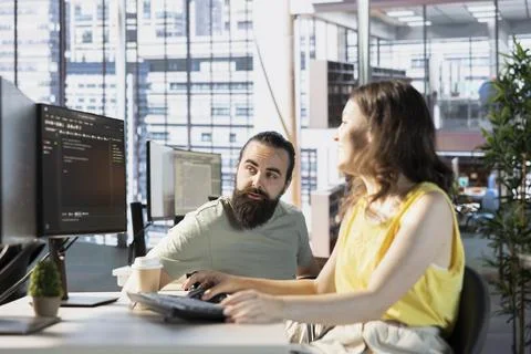Programmer asking for help from team leader in wheelchair Stock Photos