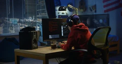 Programmer boy coding on his computer Stock Photos