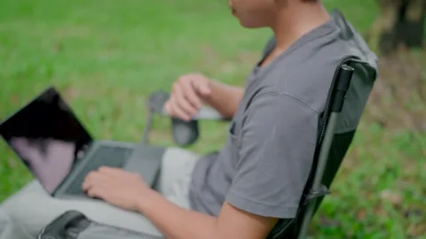 Programmer in casualwear developing new software writing program code on a lapto Stock Footage 283186613