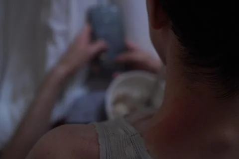 A programmer checks programs on a smartphone while sitting at a meal before 스톡 사진