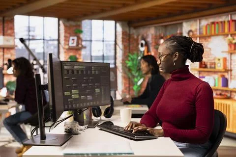 Programmer coding advanced AI algorithm in startup workspace Stock Photos