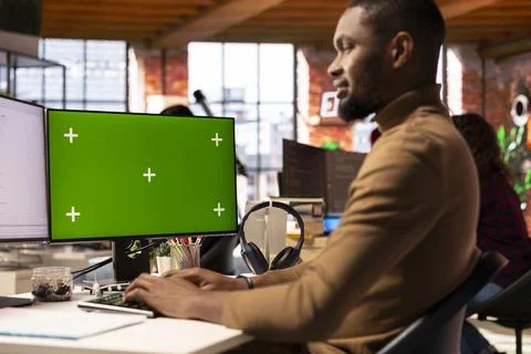 Programmer coding in AI startup office using mockup PC Stock-Fotos