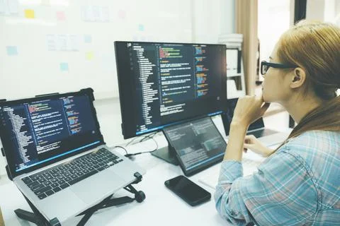 Programmer is coding and programming software. Stock Photos