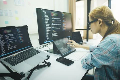 Programmer is coding and programming software. 스톡 사진