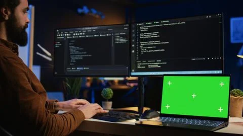 Programmer coding on computer next to isolated screen laptop in home office 스톡 사진