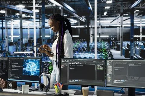 Programmer coding in data center, updating machine learning scripts Stock-Fotos