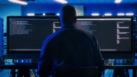 Programmer Coding on Dual Monitor PC in Data Center Stock-Footage 269052962