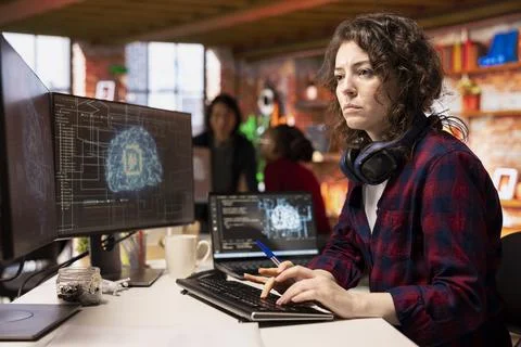 Programmer coding in fast paced AI startup office, building scalable solutions Foto stock