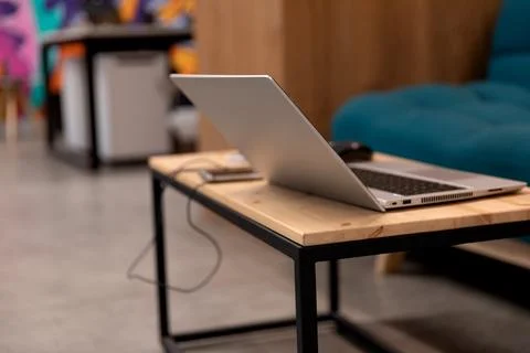 A programmer coding at lap top at coworking space Stock Photos