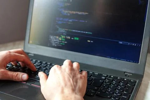Programmer coding on laptop. Coder hands typing program code Stock Photos