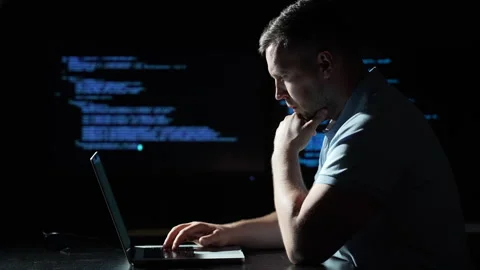 Programmer coding on a laptop computer. Programmer working with code on multiple Stock-Footage 346697354